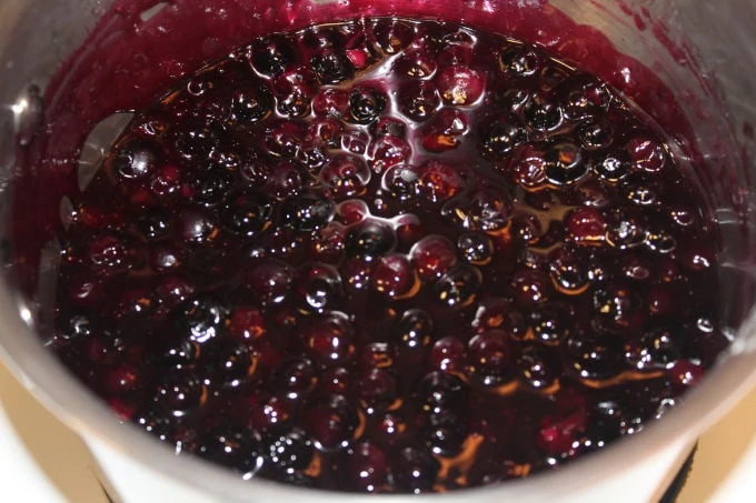 Blueberry pie filling in a saucepan.