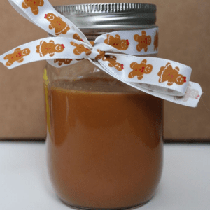 Cajeta sauce in a mason jar and tied with a ribbon.