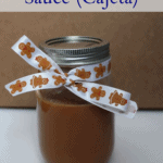 Cajeta sauce in a mason jar tied with a ribbon.