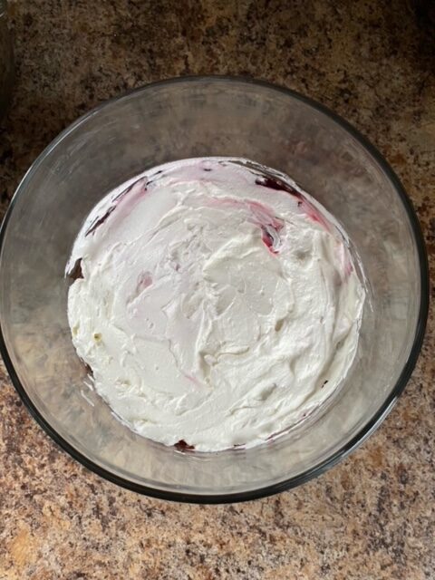 Whipped cream layered in trifle dish.