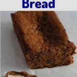 Malt bread loaf with a slice cut from it. The slice has butter on it.
