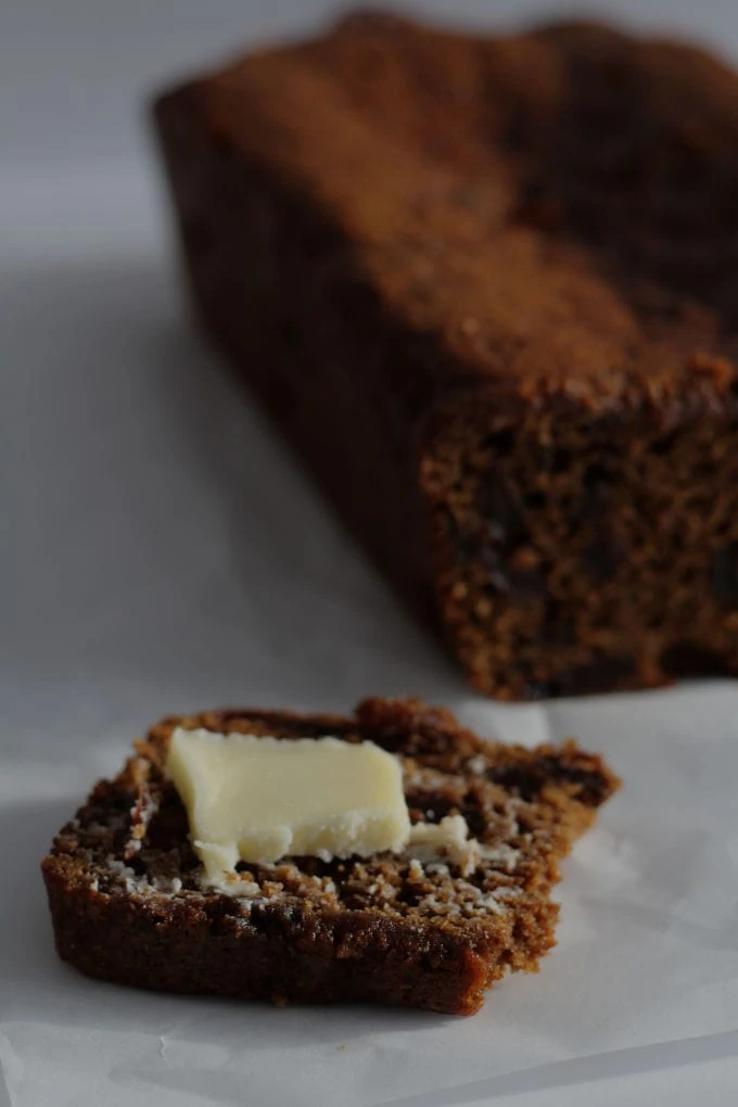 A slice of malt bread with some butter on top.
