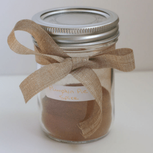 A jar of spice with a bow around it.