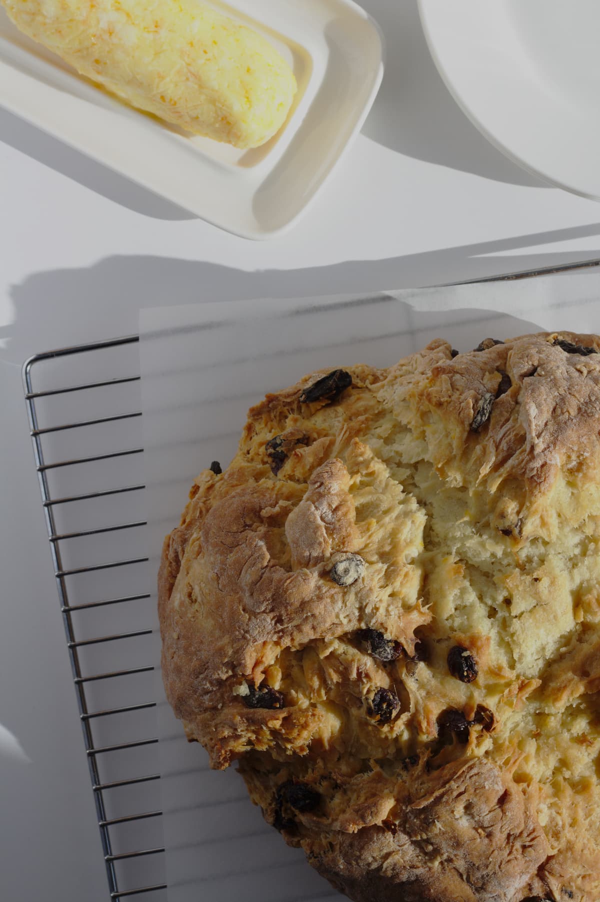 Irish Soda bread viewed from above with a brick of orange butter to the side.