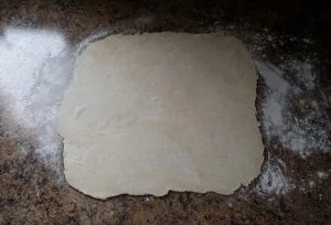 pie dough rolled out on floured surface.