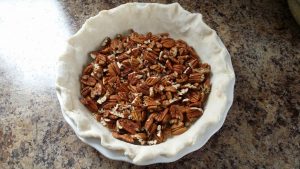 pecans in the bottom of the pie dish.