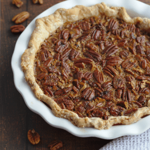 A whole pecan pie in a pie dish.