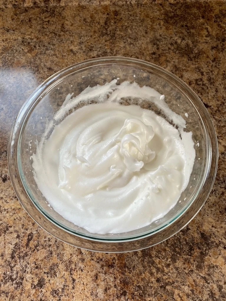 Egg whites with sugar and whipped until stiff peaks.