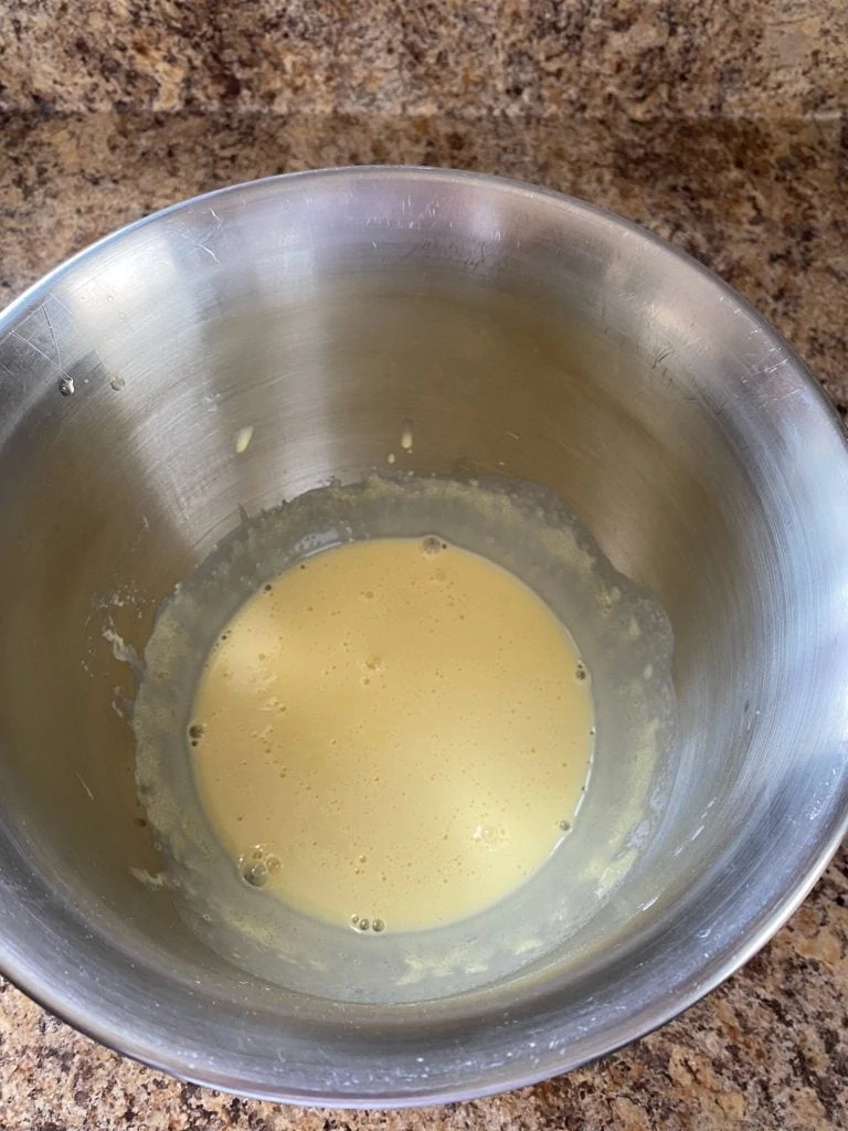 Egg yolks with milk and vanilla extract stirred in.