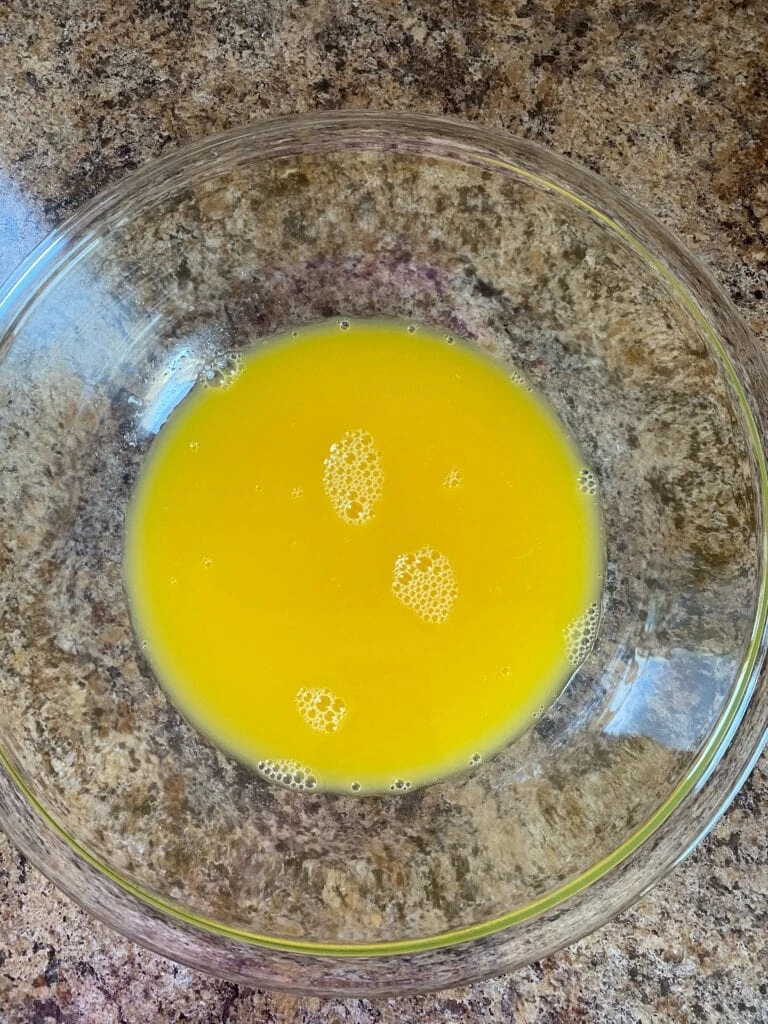 Orange juice and sugar in a bowl.