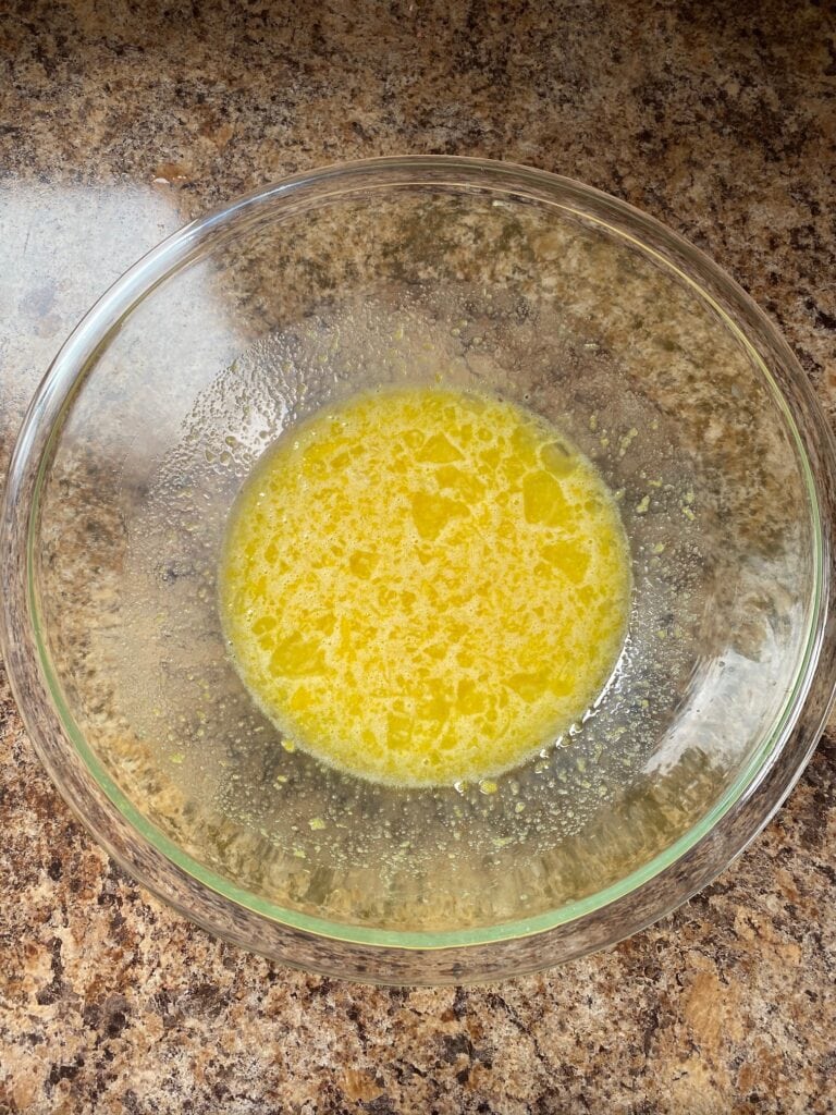 Sugar, eggs, lemon juice and lemon zest in a bowl.