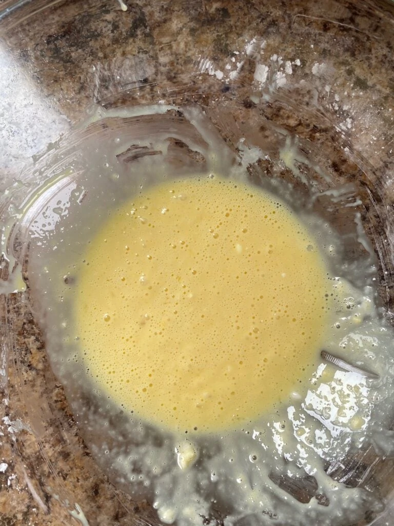 Eggs and cornstarch mixed together in a bowl.