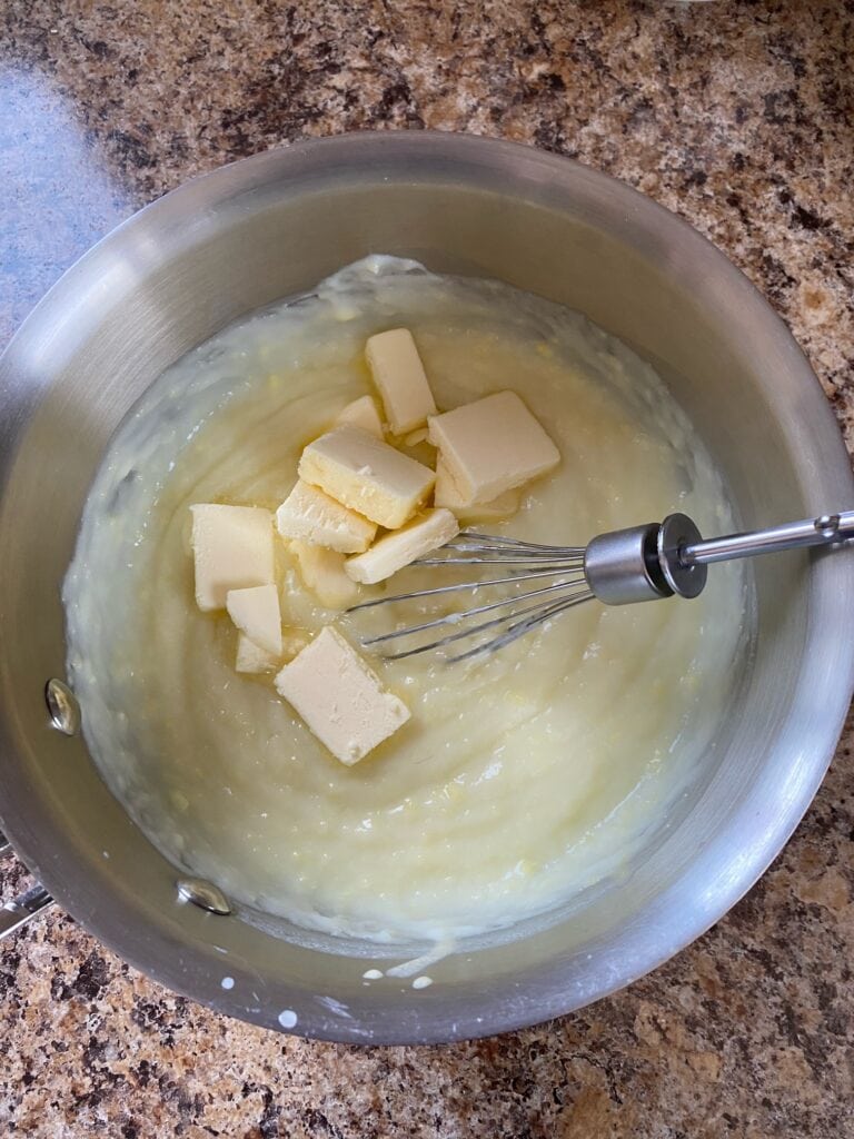 Butter on top of pudding in a saucepan.