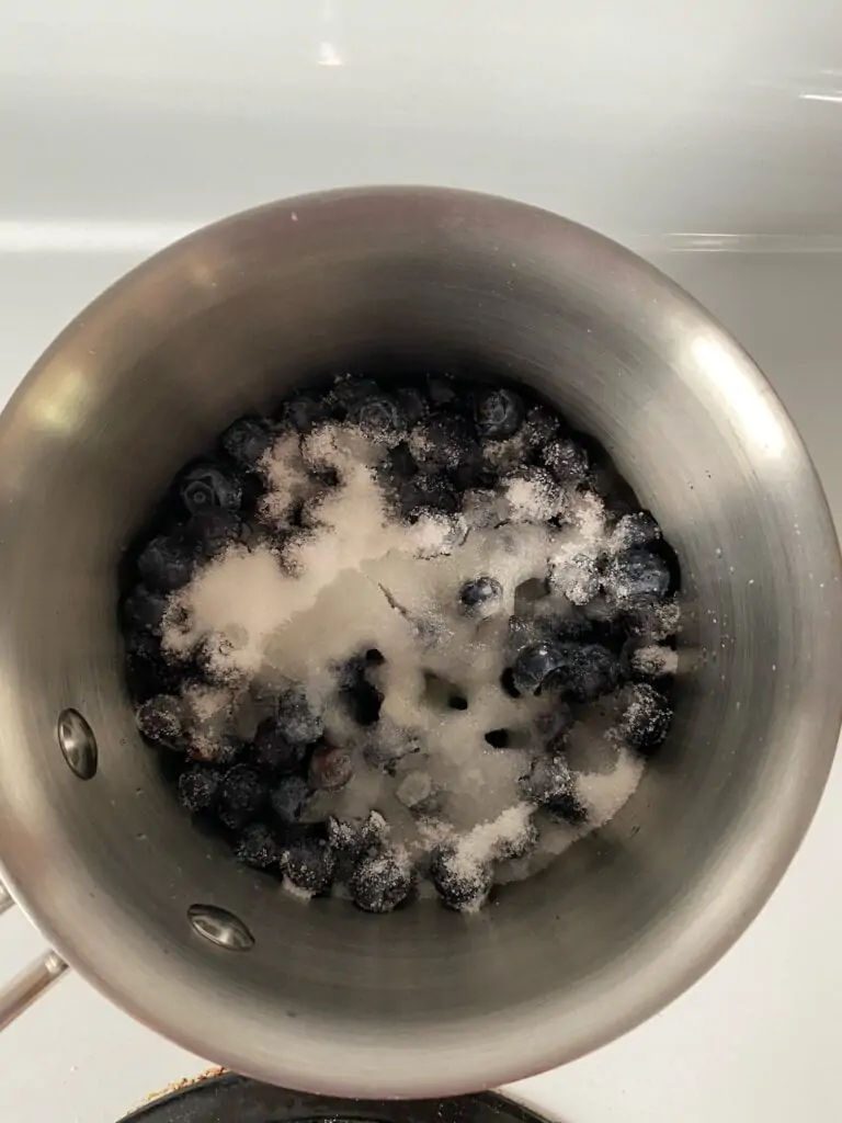 Blueberries, sugar, and lemon juice in a saucepan.