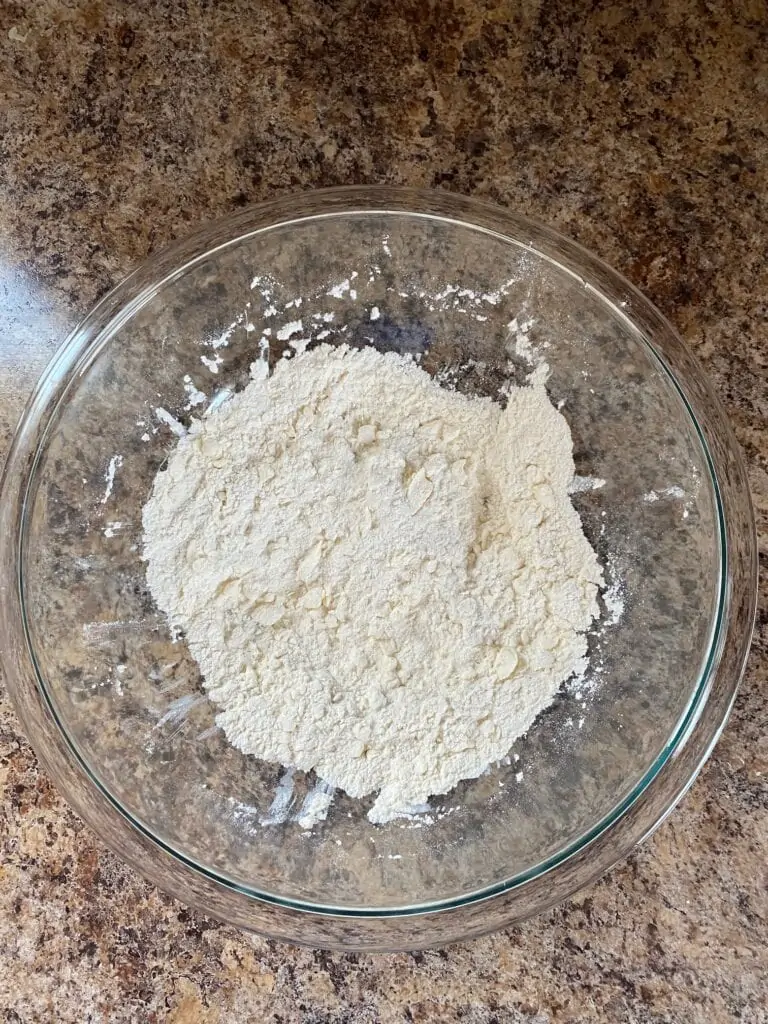 Butter added to the flour mixture bowl.