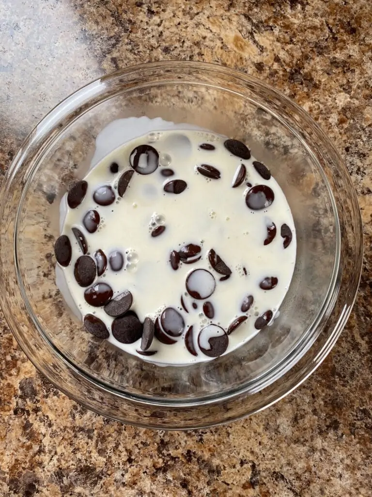 Heavy whipping cream and chocolate in a bowl.