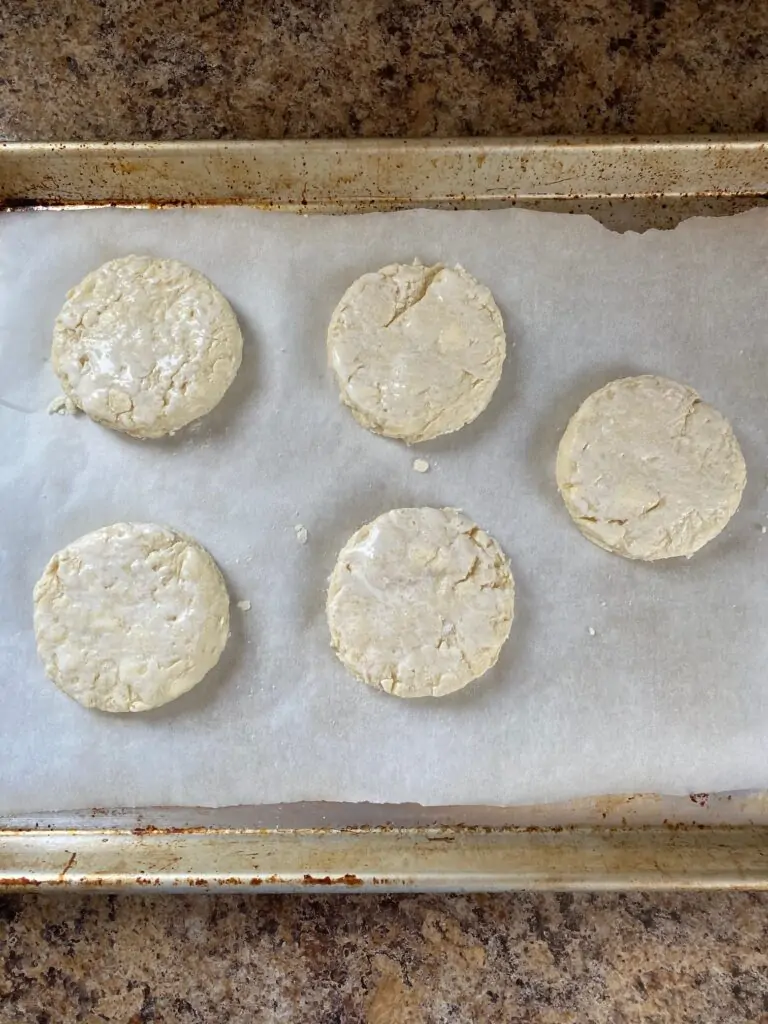 Biscuits cut into rounds and put on a baking sheet.