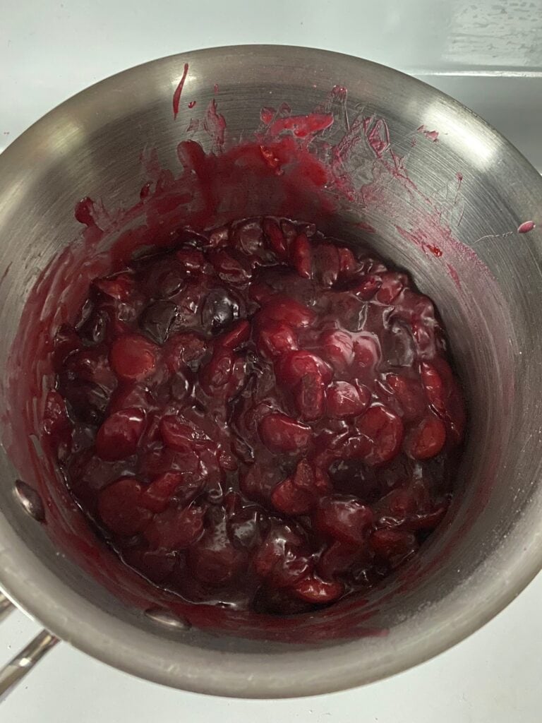Cherry pie filling has thickened up in the saucepan.