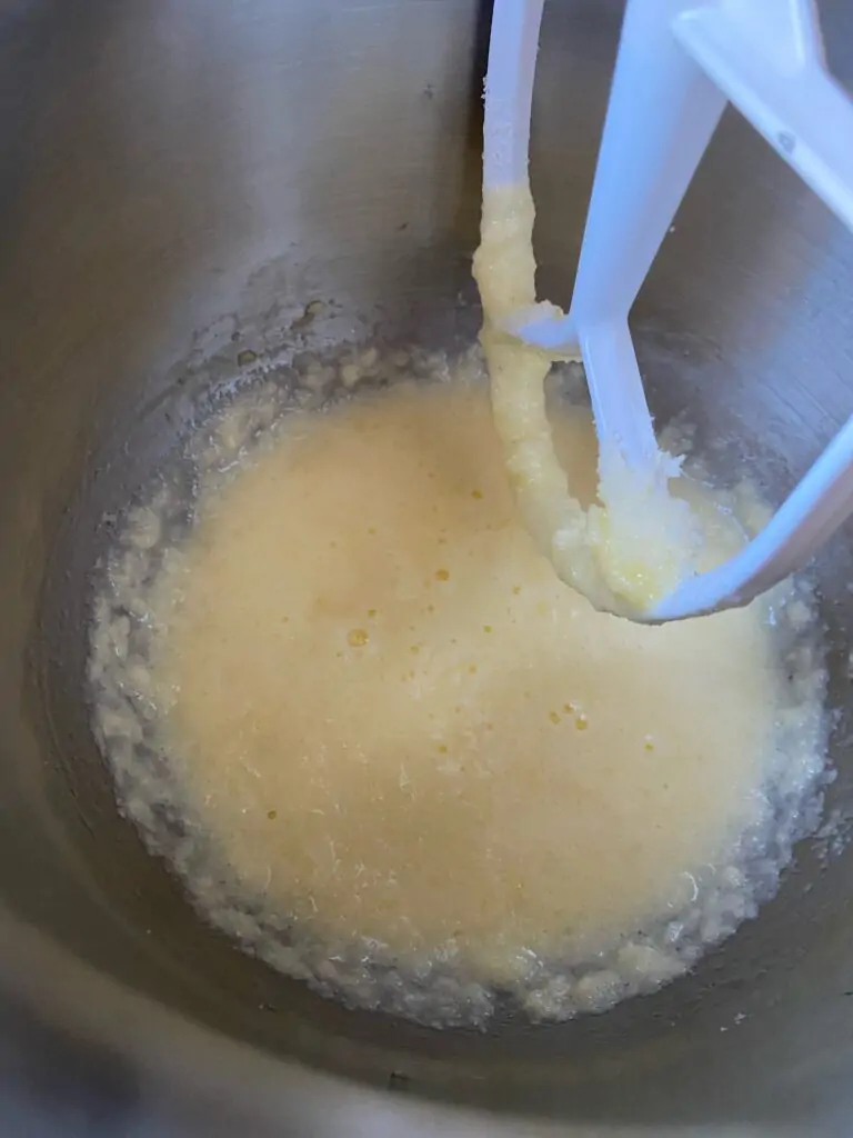 Eggs mixed into butter and sugar mixture.