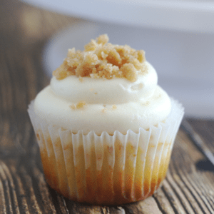 A cupcake with crumble on top of the frosting.