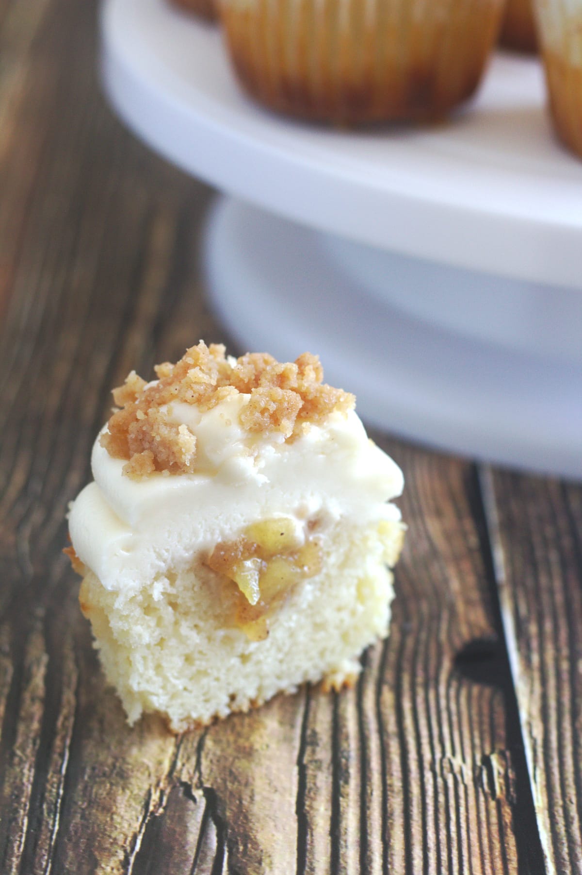 A cupcake cup open so the apple pie filling can be seen.
