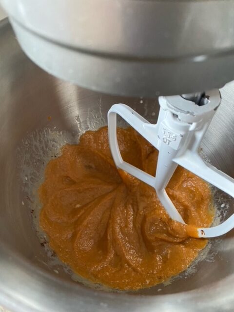 Pumpkin puree, sugar, and spices added to the bowl.