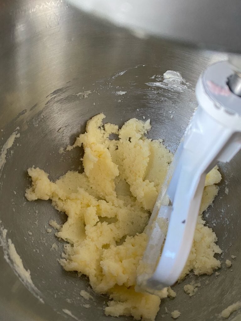 Butter and sugar mixed together in a mixing bowl.