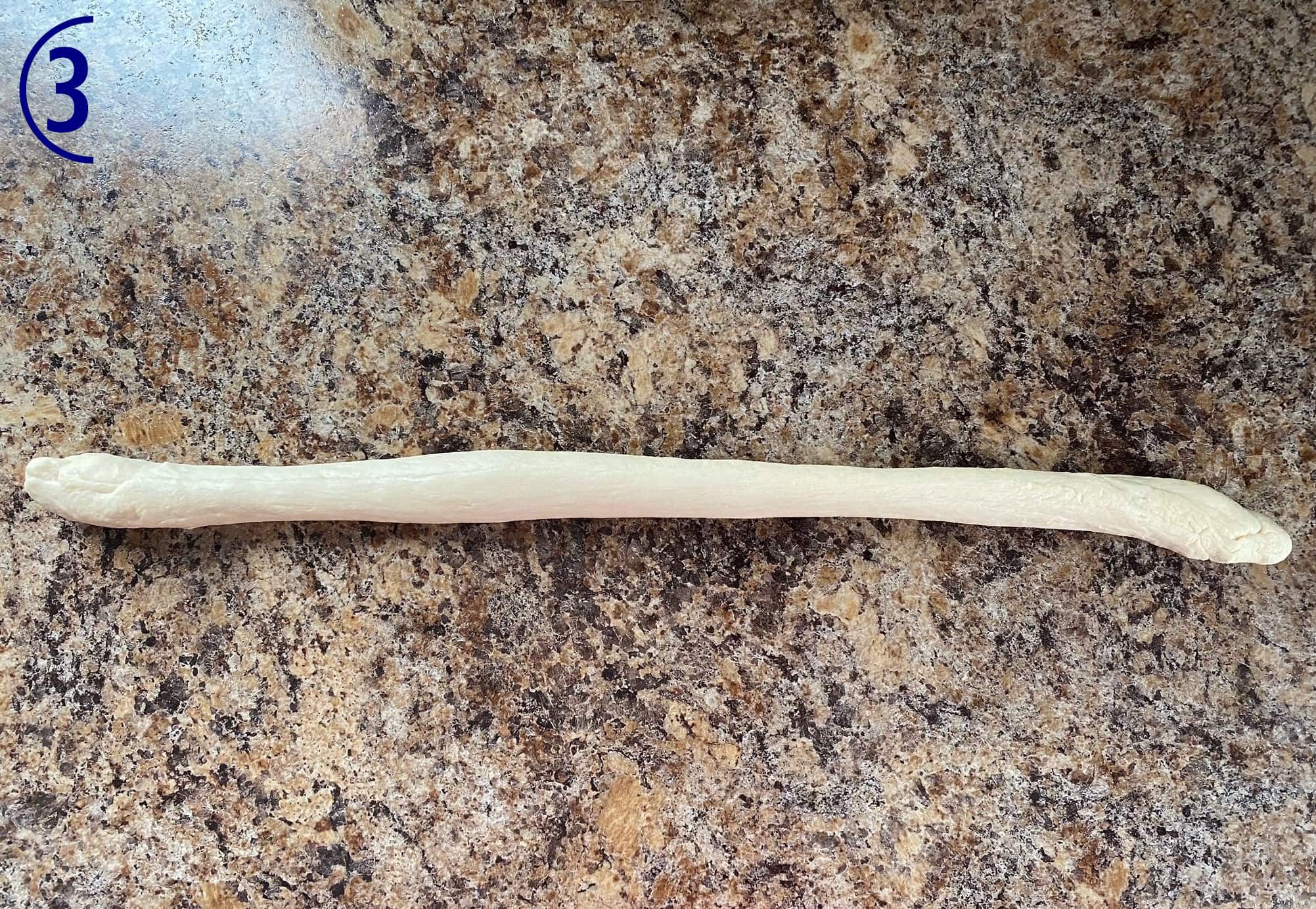 A piece of dough rolled out into a long thin rope.