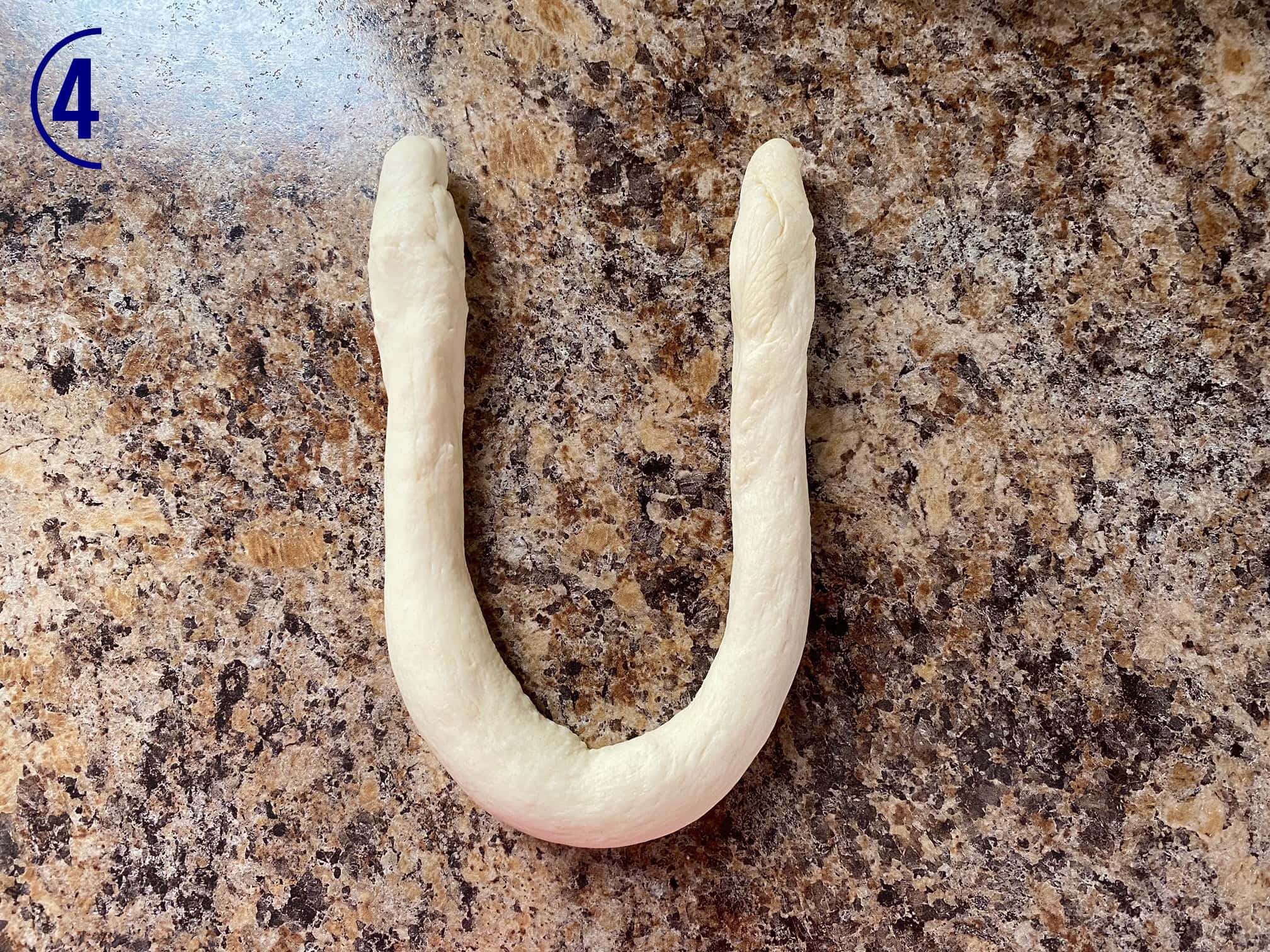 Dough rope has ends turned up to mimic a "u" shape.
