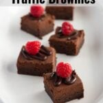 Brownies on a long white plater with a ruffled edge.