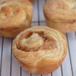Cruffins on a wire rack.