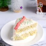 A slice of cake on a white plate.