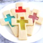 Four cookies on a white plate.