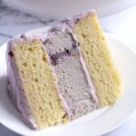 A slice of cake on a white plate.