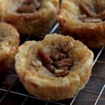 Butter tarts on a wire cooling rack.