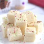 A pile of fudge pieces on a white plate.