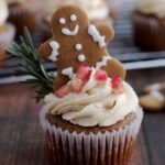 A cupcake with a gingerbread man on top.