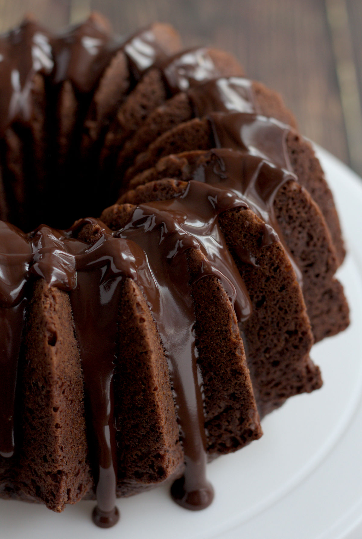 A Bundt cake on a white cake stand.