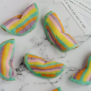 Fortune cookies scattered around on a marble surface.