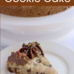 A slice of cookie cake on a white plate.