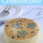A whole cheesecake on a white cake plate.