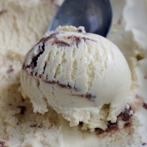 A scoop of ice cream. The ice cream scoop is in the background.