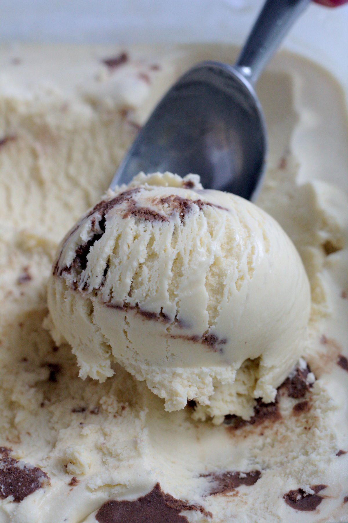 A scoop of ice cream. The ice cream scoop is in the background.