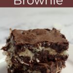 Two brownies sitting on top of each other. They sit on a white plate.